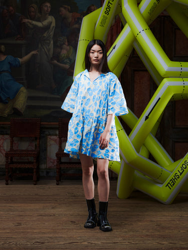 Model wearing the Henrik Vibskov Preserve Blouse in Ecru Amulets, front view. The model is 167 cm and wears size S, showing the oversized fit, V-neck with button, and wide, knee-length skirt.