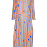 Colorful dress with geometric pattern from Henrik Vibskov on a white background