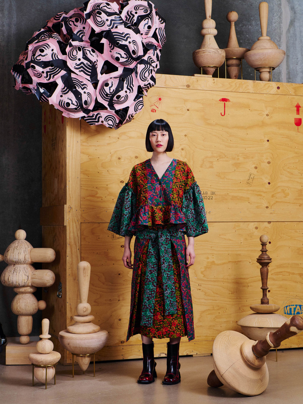 Henrik Vibskov Pumpkin Blouse in Floral Affairs styled on model with matching Leek Skirt, showing floral patchwork pattern, gathered peplum hem and voluminous sleeves. ID: ARCHIVE-F205