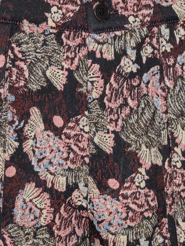 Close-up of floral and chicken patterned pants by Henrik Vibskov in navy and pink.