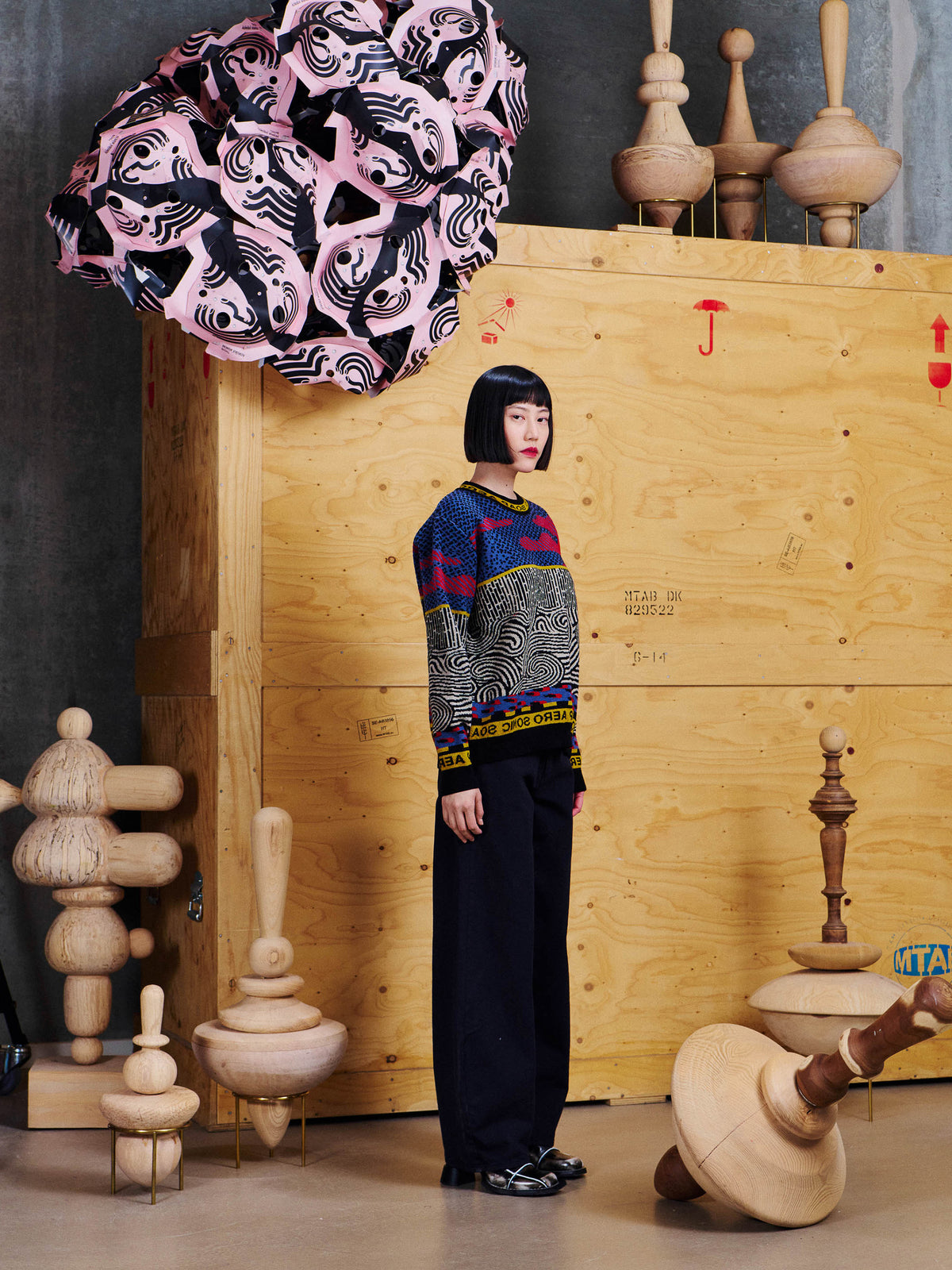Side view of model wearing Henrik Vibskov Sail Knit Sweat in Stormy Sea, showing the straight relaxed silhouette and long sleeves.