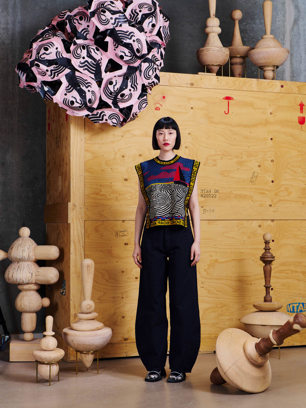 Model wearing the Henrik Vibskov Sail Knit Vest in Stormy Sea from the front, showing the sleeveless shape, graphic knit pattern and relaxed fit.