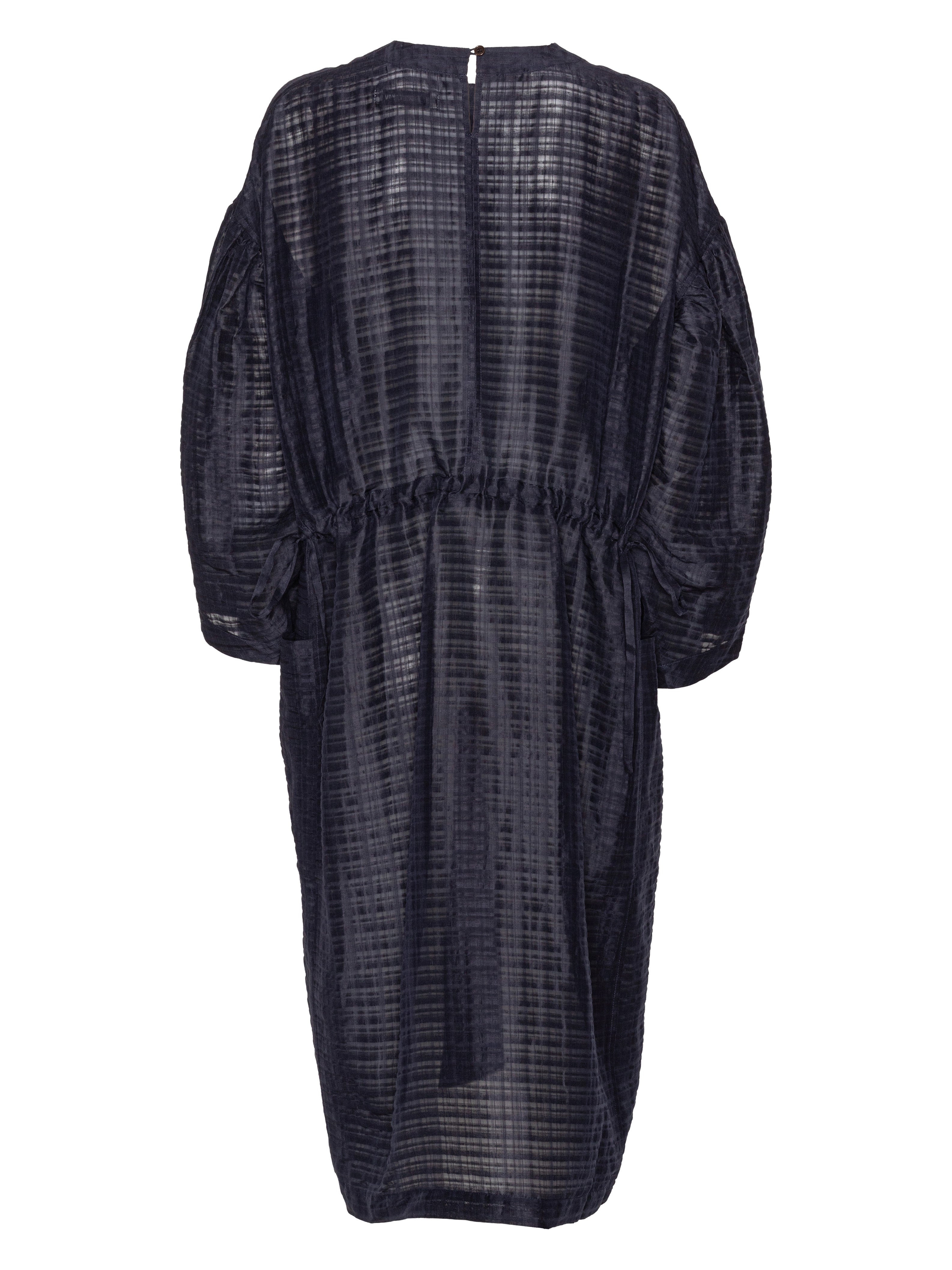 Back view of the navy long sleeve dress from Henrik Vibskov on a white background