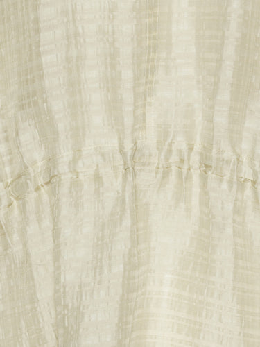 Close-up of the beige-grey dress material