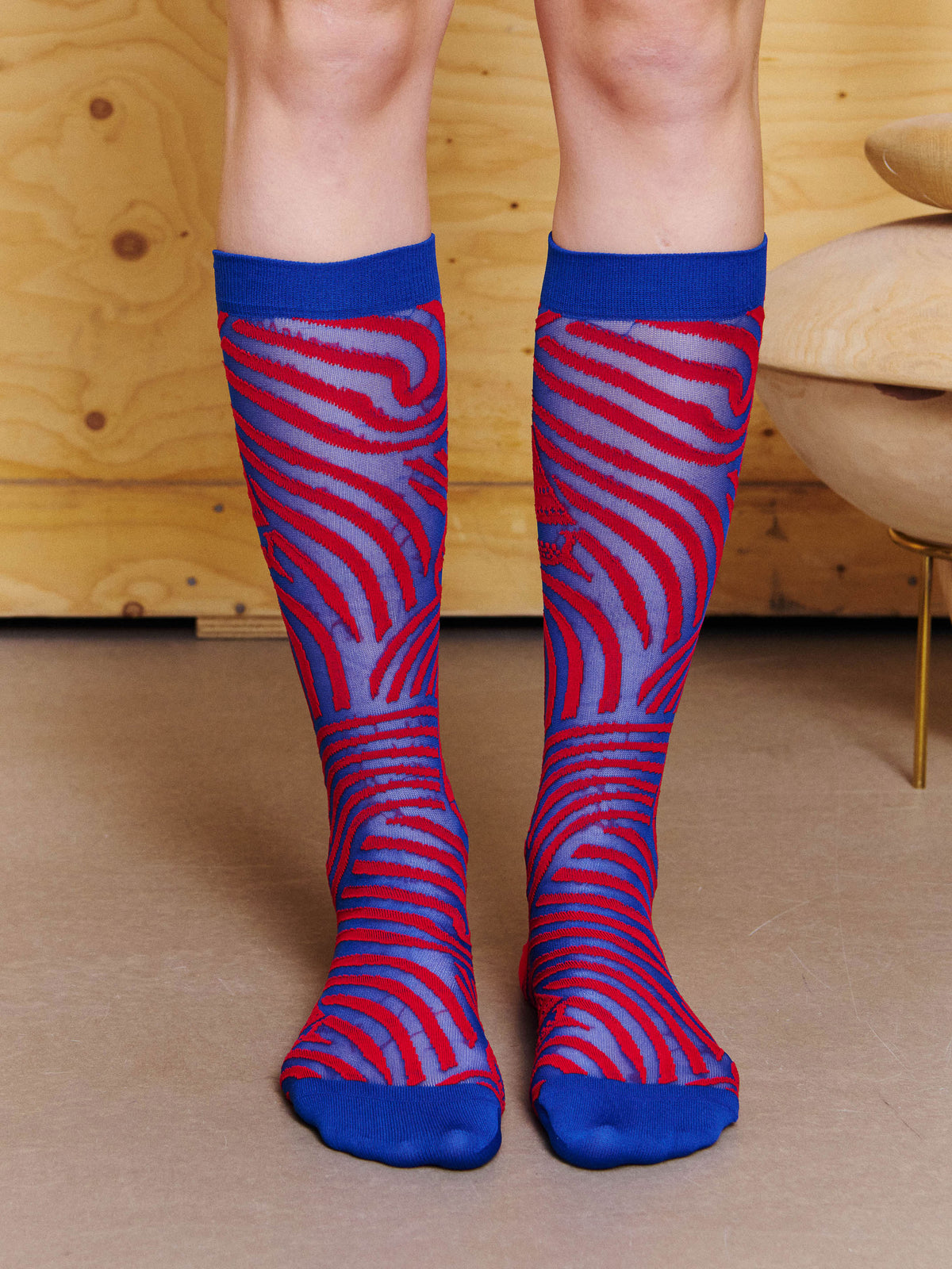 Front view of model wearing the Henrik Vibskov Stormy Sea Socks in Blue Red Stormy Sea, showing the mid-calf length and all-over wave pattern.