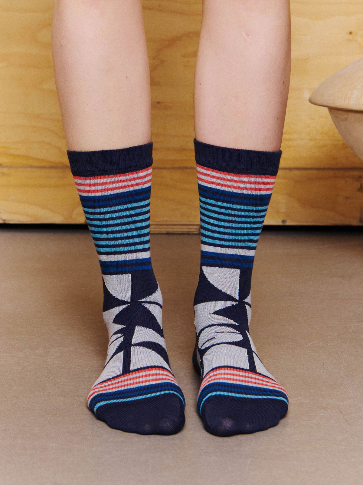 Henrik Vibskov Vibs In Bobs Socks in Black worn front view, showing the striped calf-length design and graphic motif.