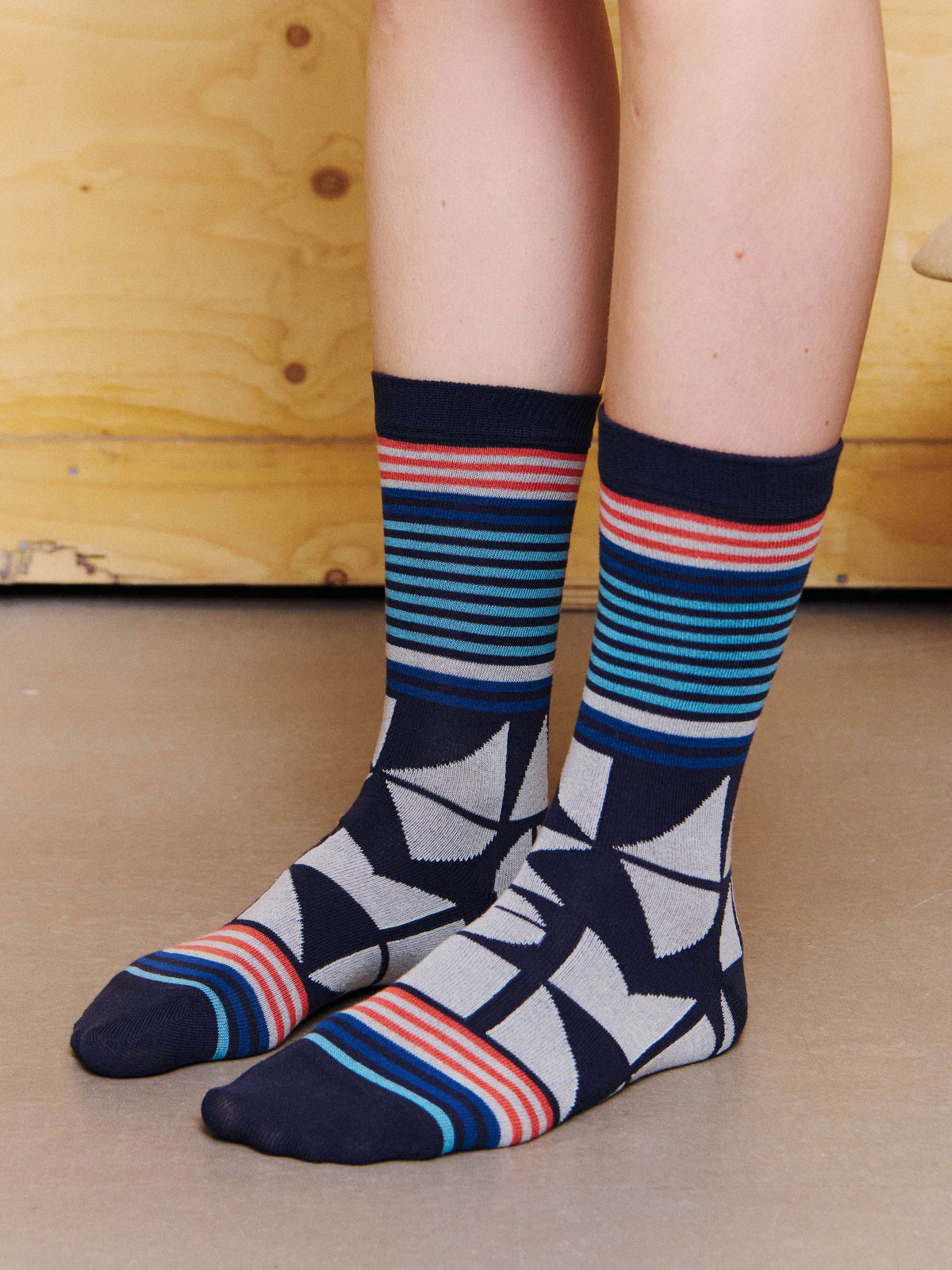 Henrik Vibskov Vibs In Bobs Socks in Black worn side view, showing the contrast stripes, intarsia pattern and dark heel and toe.