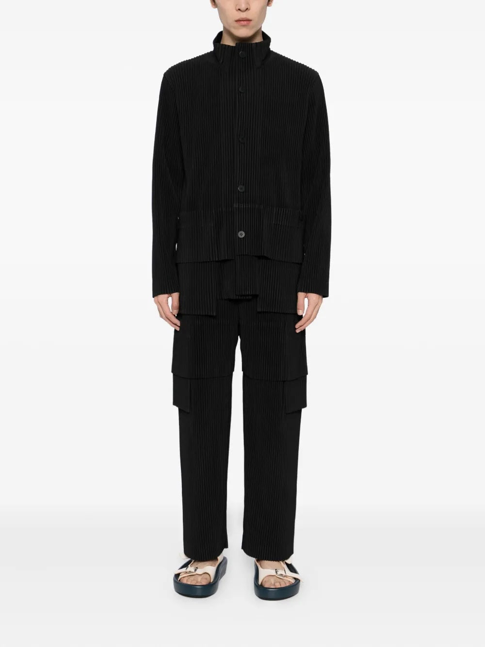 Person wearing a black outfit on a white background