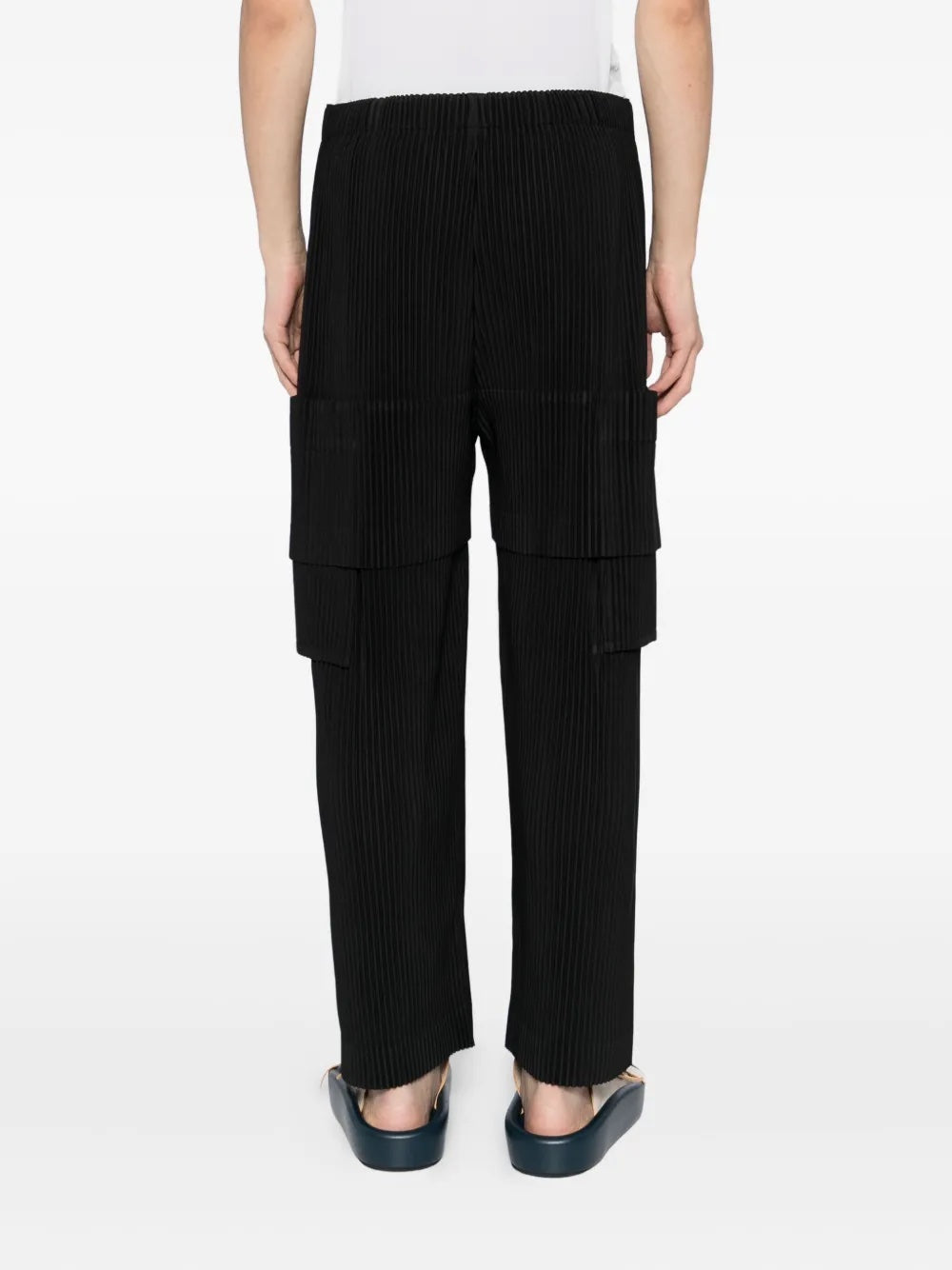 Black ribbed cargo pants worn by a person on a white background