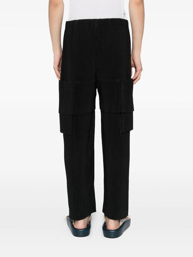 Black ribbed cargo pants worn by a person on a white background