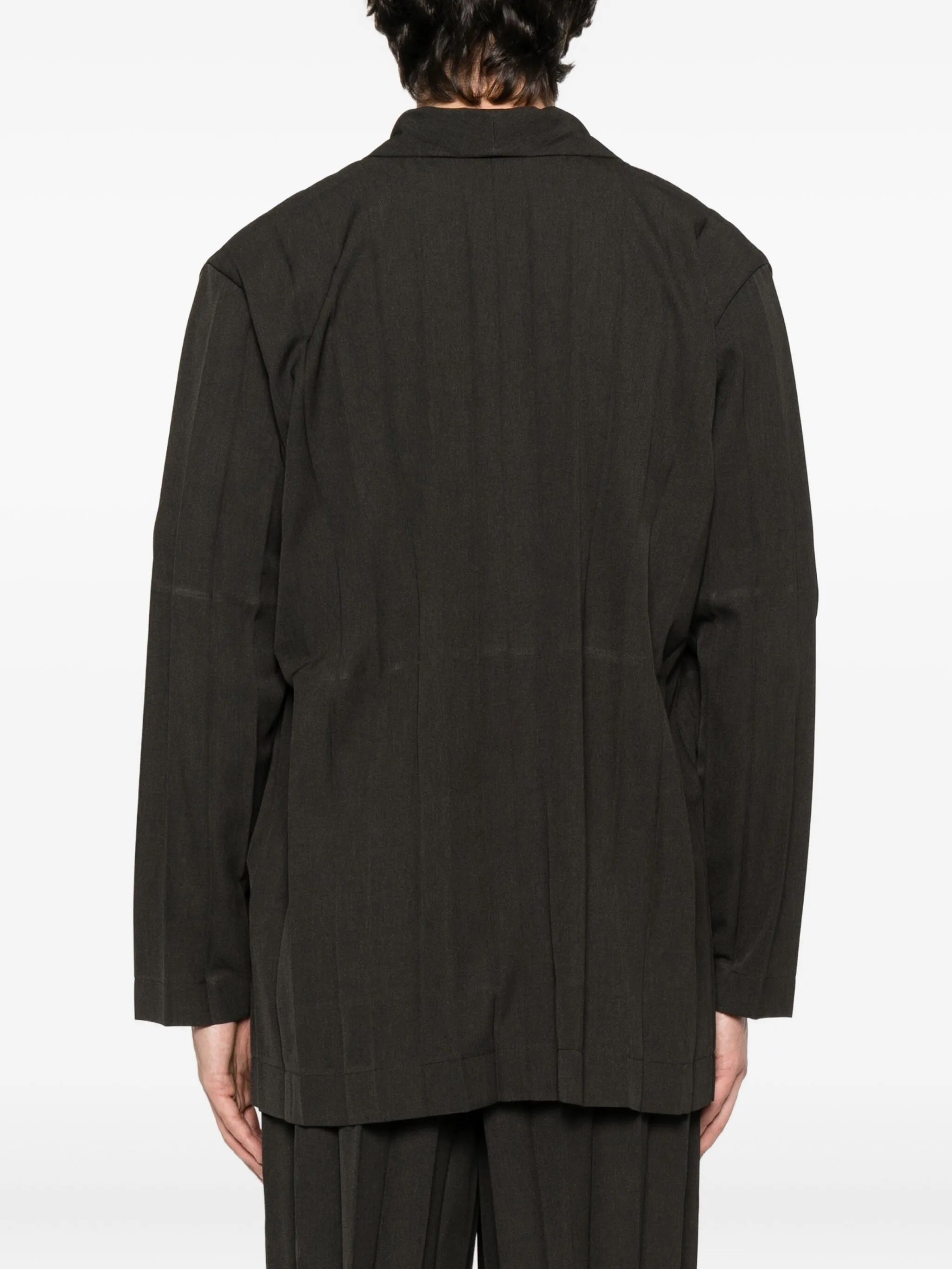 Person wearing a dark brown blazer and shorts on a white background