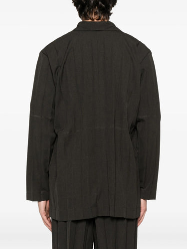 Person wearing a dark brown blazer and shorts on a white background