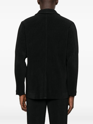 Black ribbed blazer worn by a person on a white background