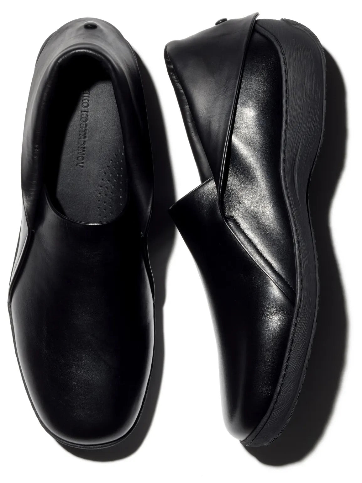 Kiko Kostadinov Iskar Slip-On Shoes in black calf leather with rounded toe, foldable back snap closure and tonal rubber sole
