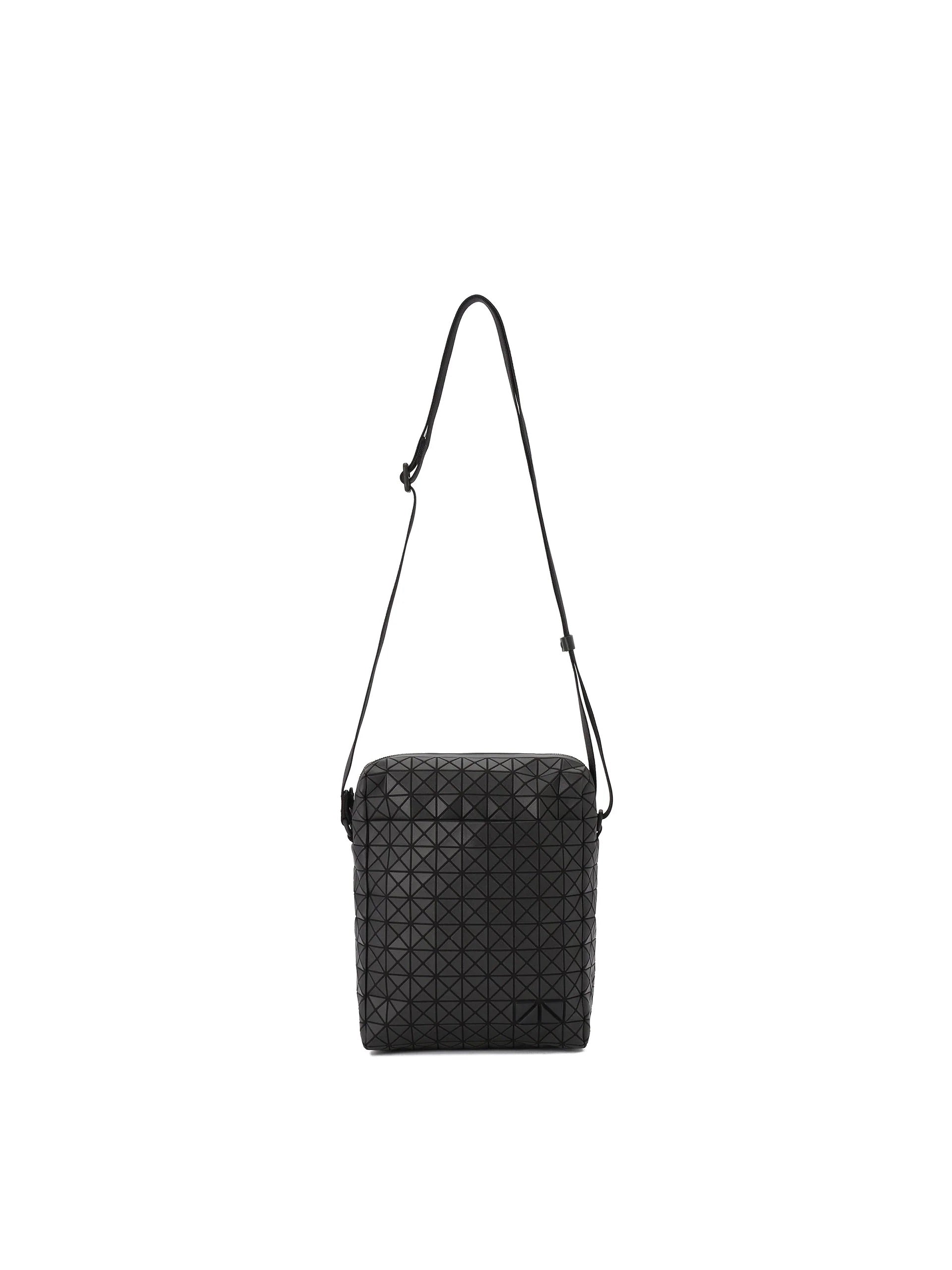 Kuro vertical shoulder bag in matte black with geometric triangular panel construction, adjustable shoulder strap and zip closure.