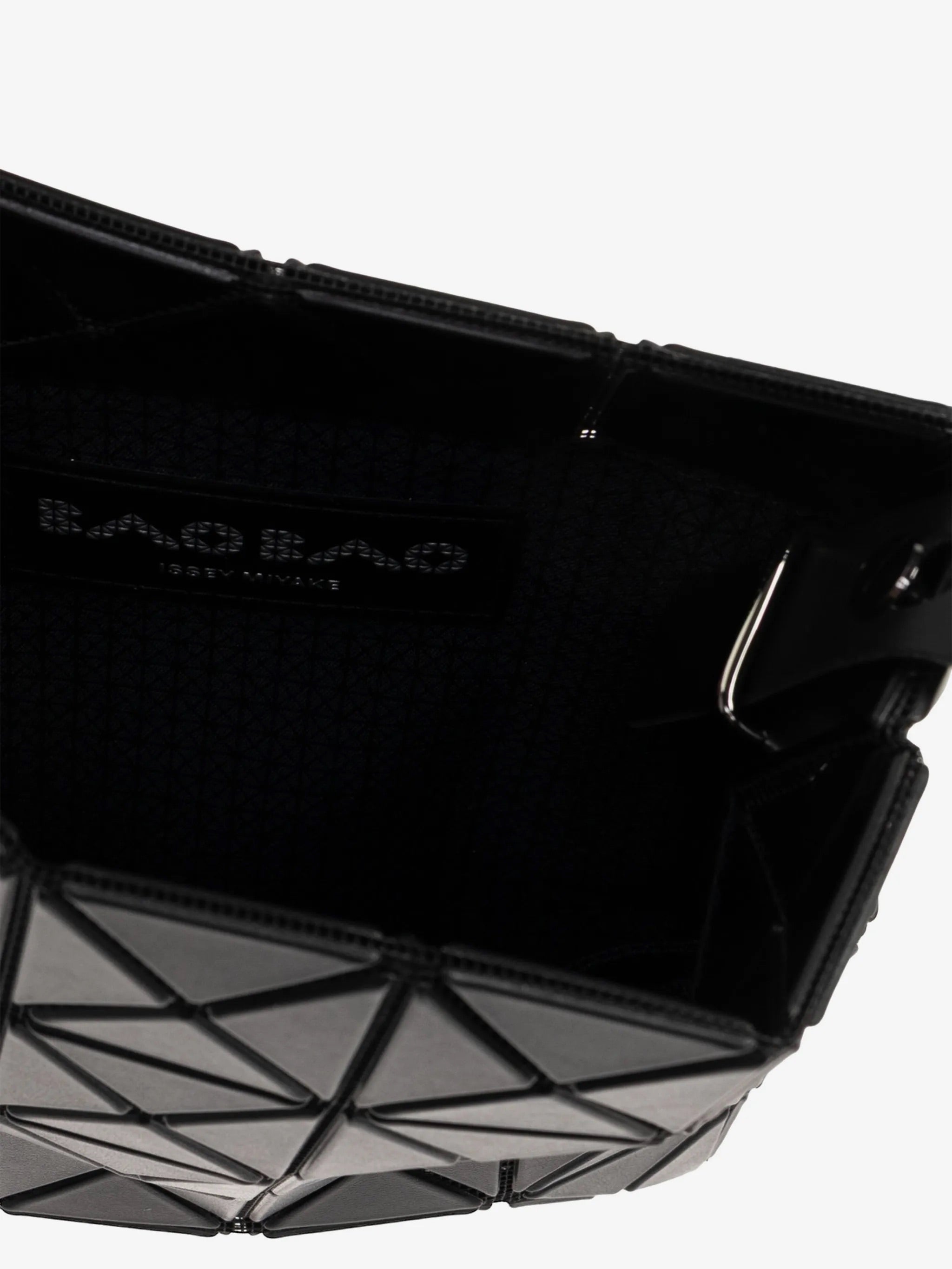 Interior view of Bao Bao Issey Miyake Prism Matte Shoulder Bag in matte black showing zip opening, inner compartment and logo patch