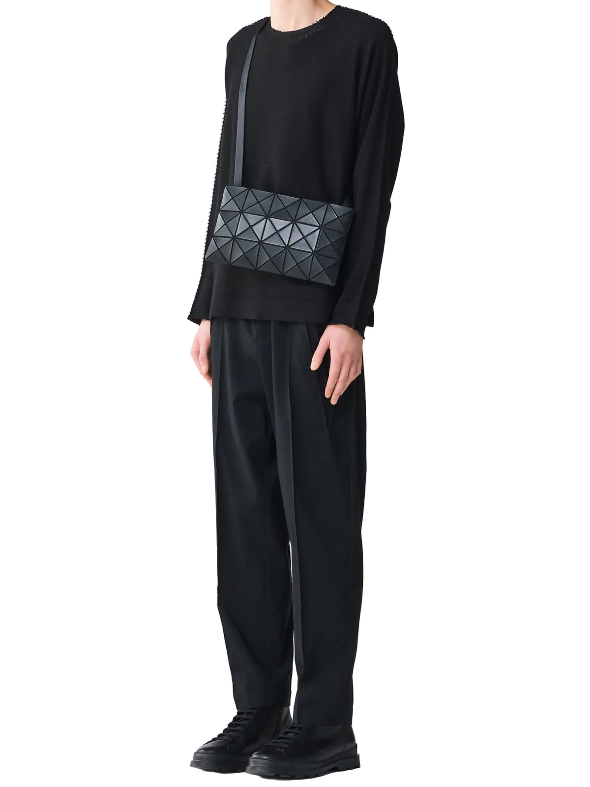 Model wearing the BAO BAO ISSEY MIYAKE September AW26 Lucent Matte Shoulder Bag 3x5 in Charcoal Grey across the body.