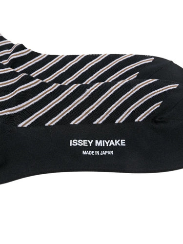 Closeup of the top of Issey Miyake December AW25 Generic Stripes Socks in black, highlighting ribbed cuff and striped pattern.