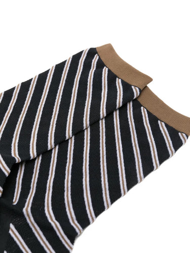 Closeup of the foot section of Issey Miyake December AW25 Generic Stripes Socks in black, showing striped design and crew-length fit.