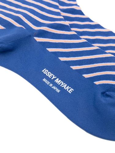Closeup of the foot section of Issey Miyake December AW25 Generic Stripes Socks in blue, showing striped design and crew-length fit.