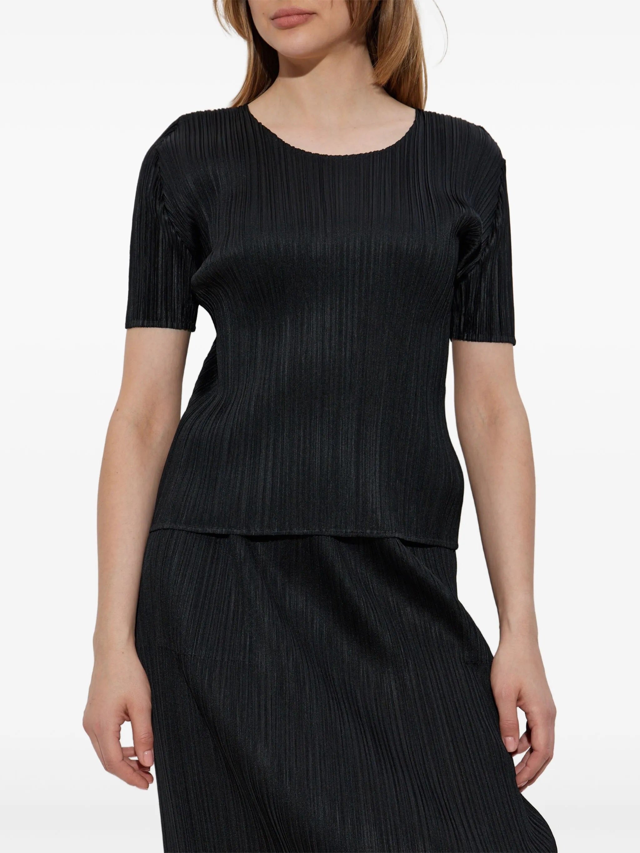 Black pleated top and skirt set on a white background