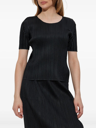 Black pleated top and skirt set on a white background