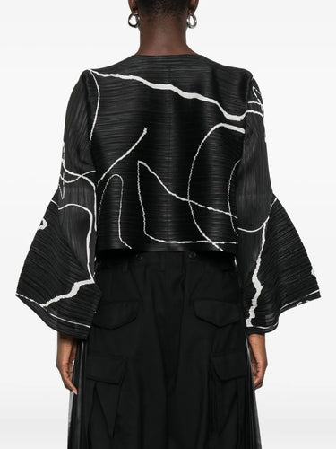 Black outfit with white abstract patterns on a plain background