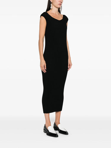 Woman wearing a black dress on a white background