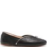 Black leather flat shoe with a zipper on a white background