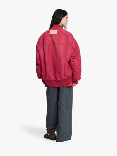 Person wearing a red jacket on a white background