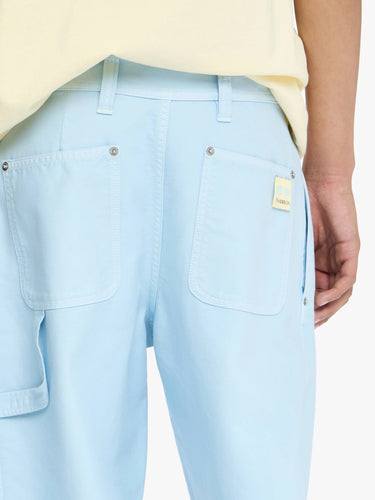 Light blue pants with a brand logo on a white background