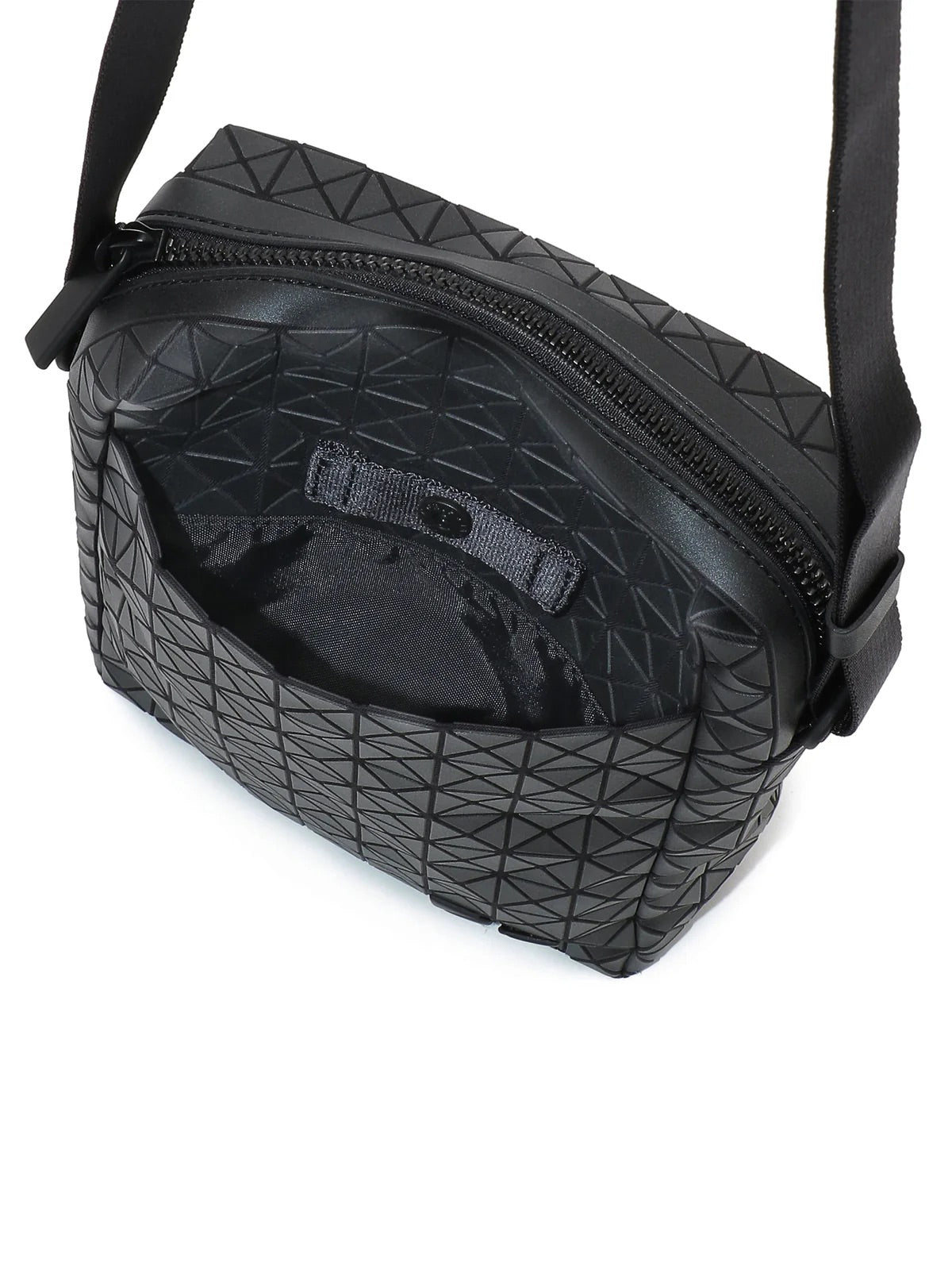 Kuro vertical shoulder bag in matte black shown from above, featuring geometric panels, zip opening and interior compartments.