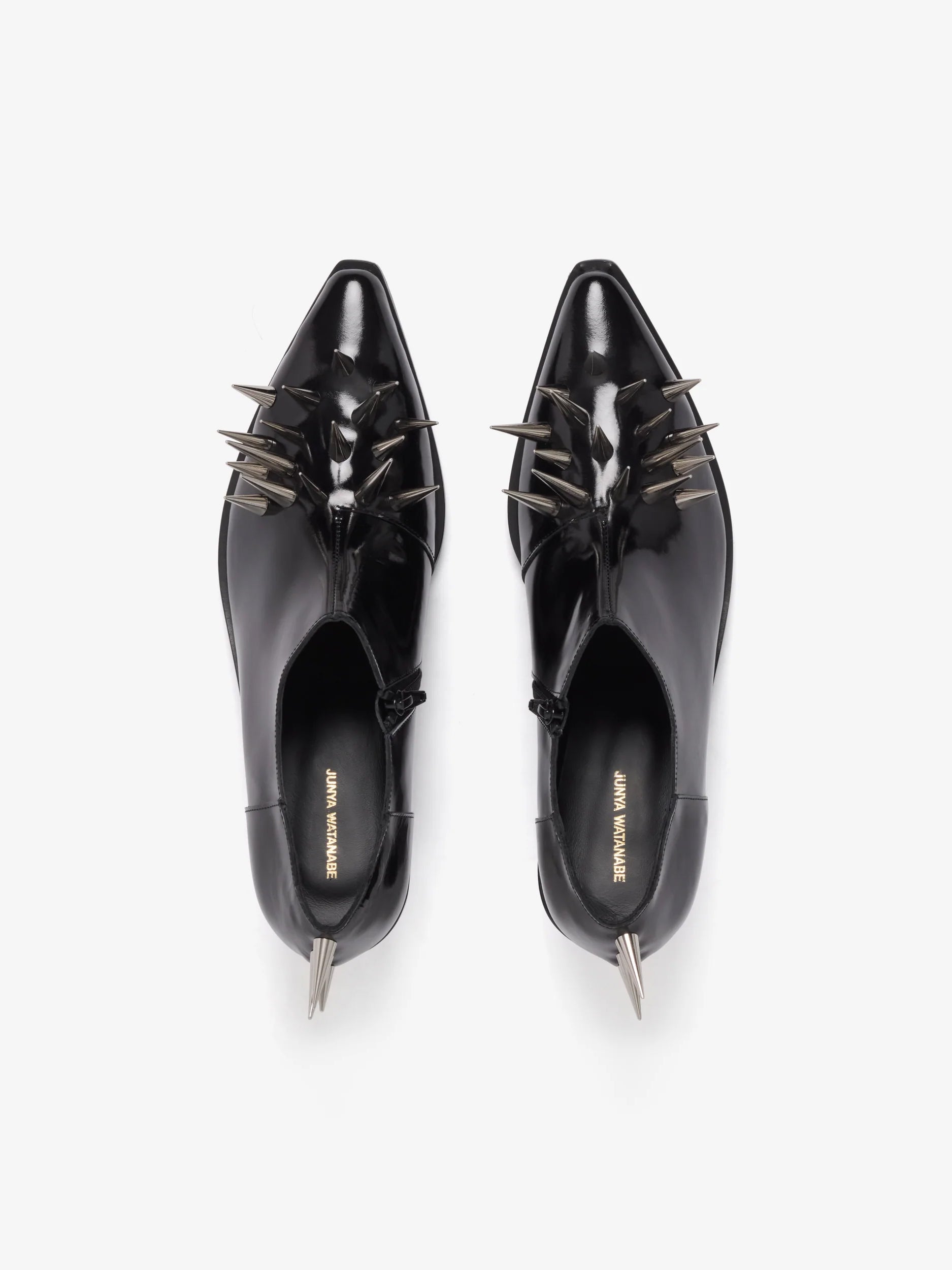 Junya Watanabe Women's Spiked Leather Shoes in Black, top view showing the pair with pointed toes and glossy patent leather finish.