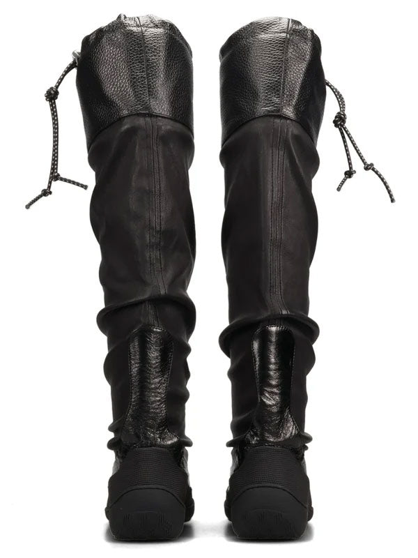Kiko Kostadinov Avocet Leather Boots in Ink Black shown upright from the front, highlighting the elongated knee-high silhouette, gathered leather shafts and drawcord details at the top.