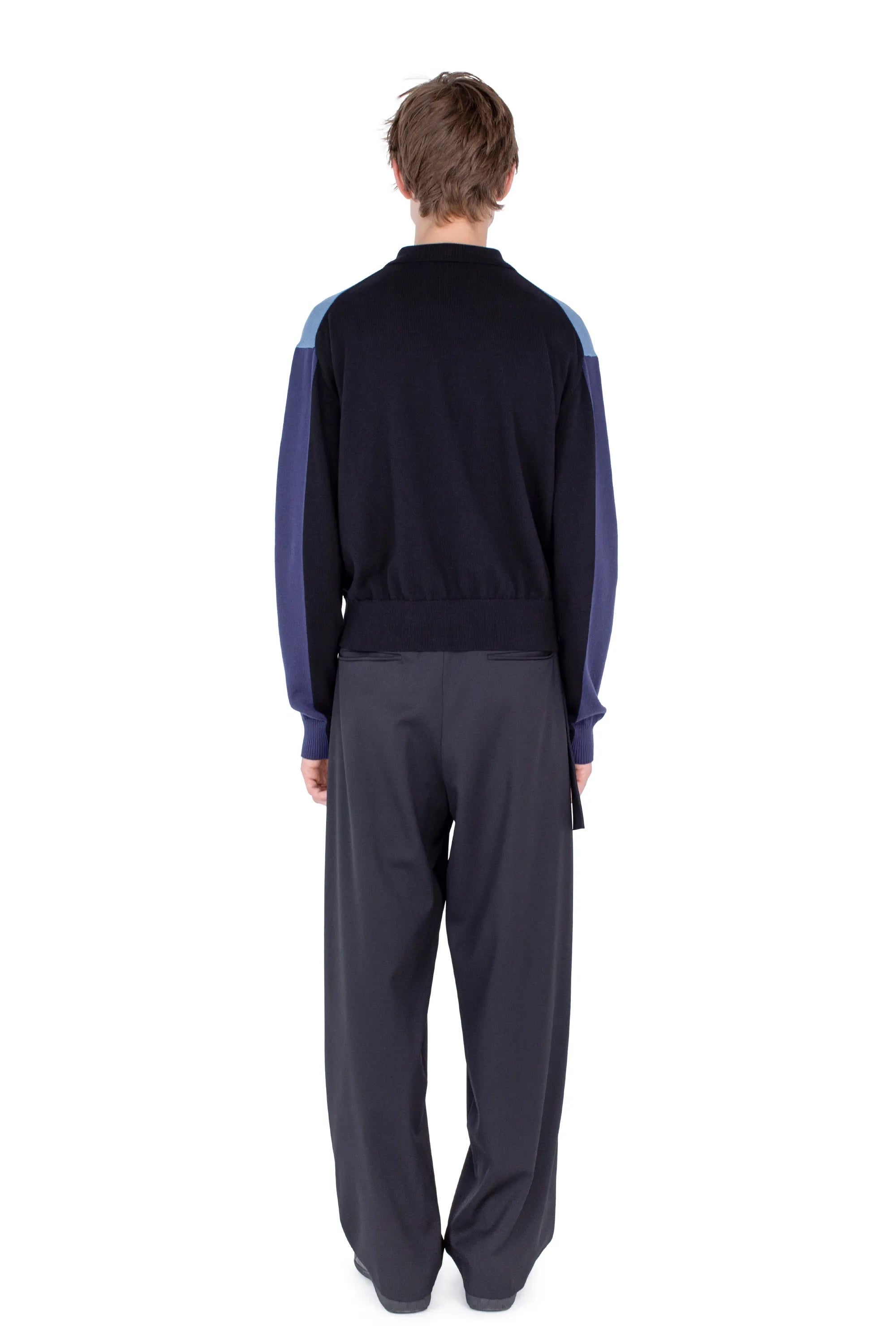 Back view of Kiko Kostadinov Munno Knit Cardigan in Phantom Black showing colour-block sleeves, ribbed hem and relaxed fit
