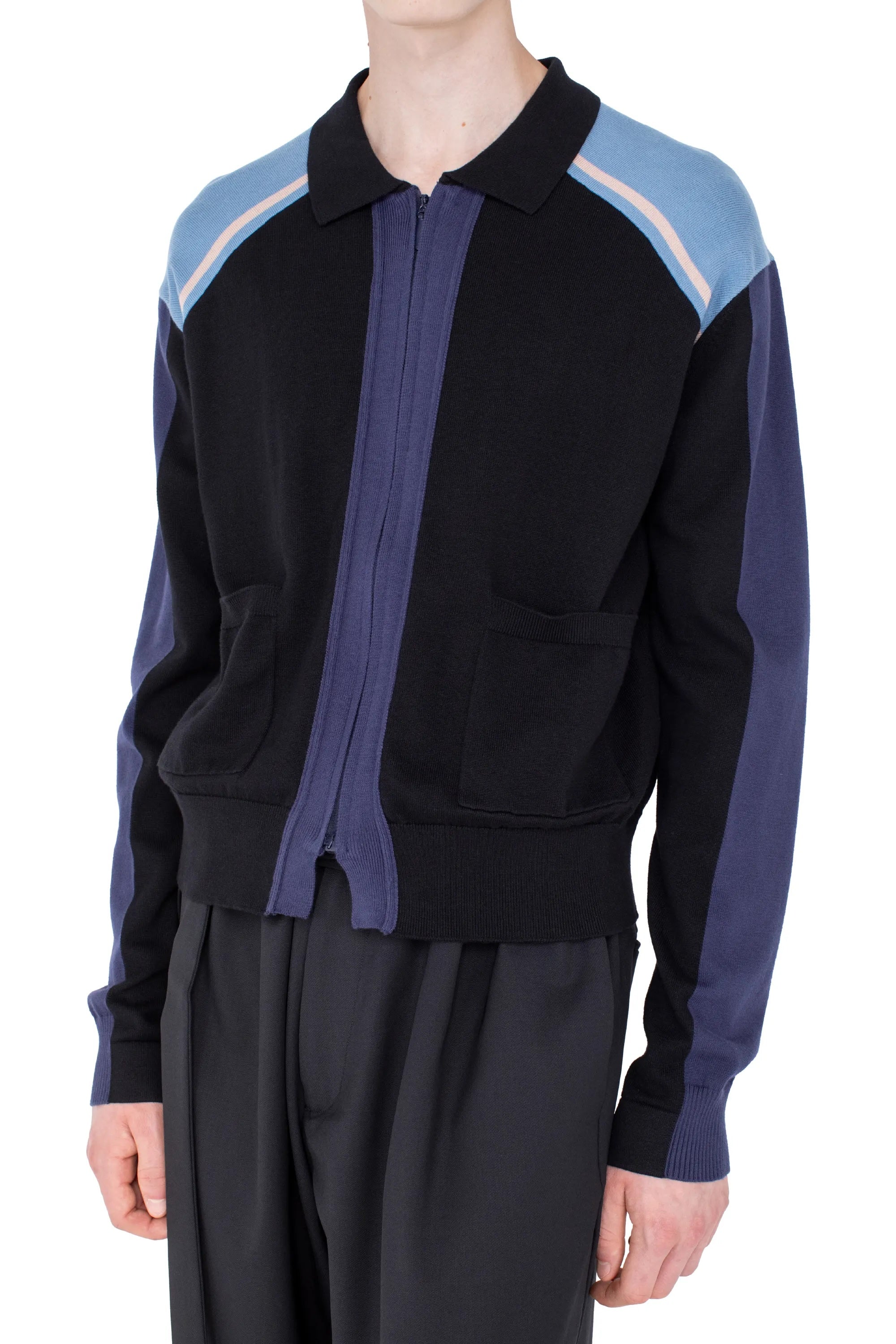 Close-up of Kiko Kostadinov Munno Knit Cardigan showing black polo collar, blue shoulder panels, front zip fastening and knit patch pockets