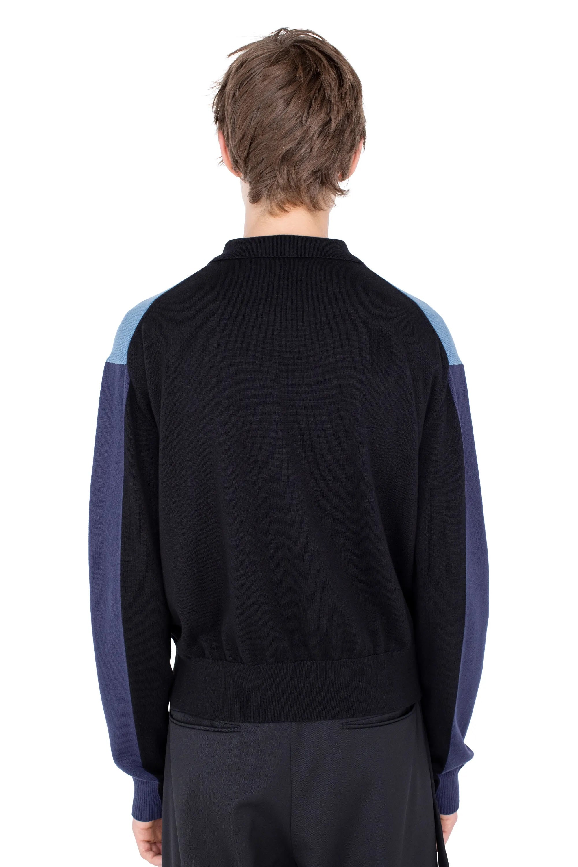 Close-up back view of Kiko Kostadinov Munno Knit Cardigan in Phantom Black with blue sleeves, light blue shoulders and ribbed waistband