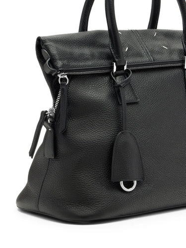 Maison Margiela 5AC Soft Medium in black, close-up of four-stitch logo, leather tassel pulls and silver-tone zip hardware