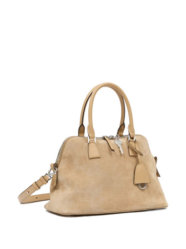 Side view of the Maison Margiela 5AC Soft Medium in camel, highlighting the soft suede texture, expandable silhouette, and detachable shoulder strap.