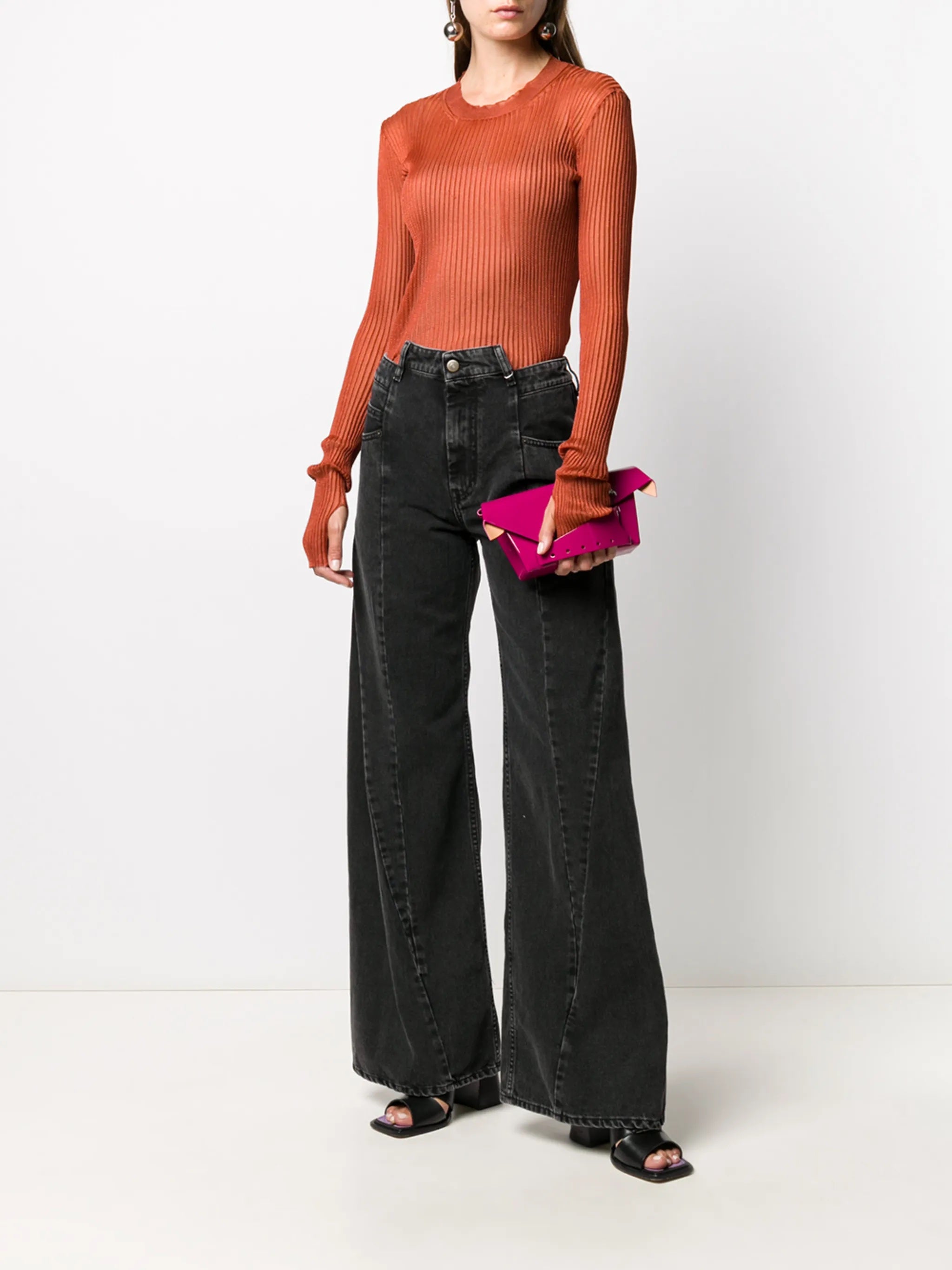 Model wearing the Medium Black Stone Maison Margiela five-pocket pants, shown from the front with a high-waisted fit, washed black denim, and wide legs.