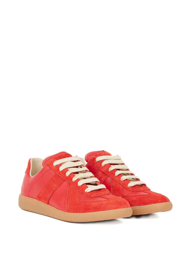 Red sneakers with white laces on a white background