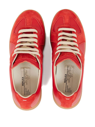 Red sneakers with white laces on a white background