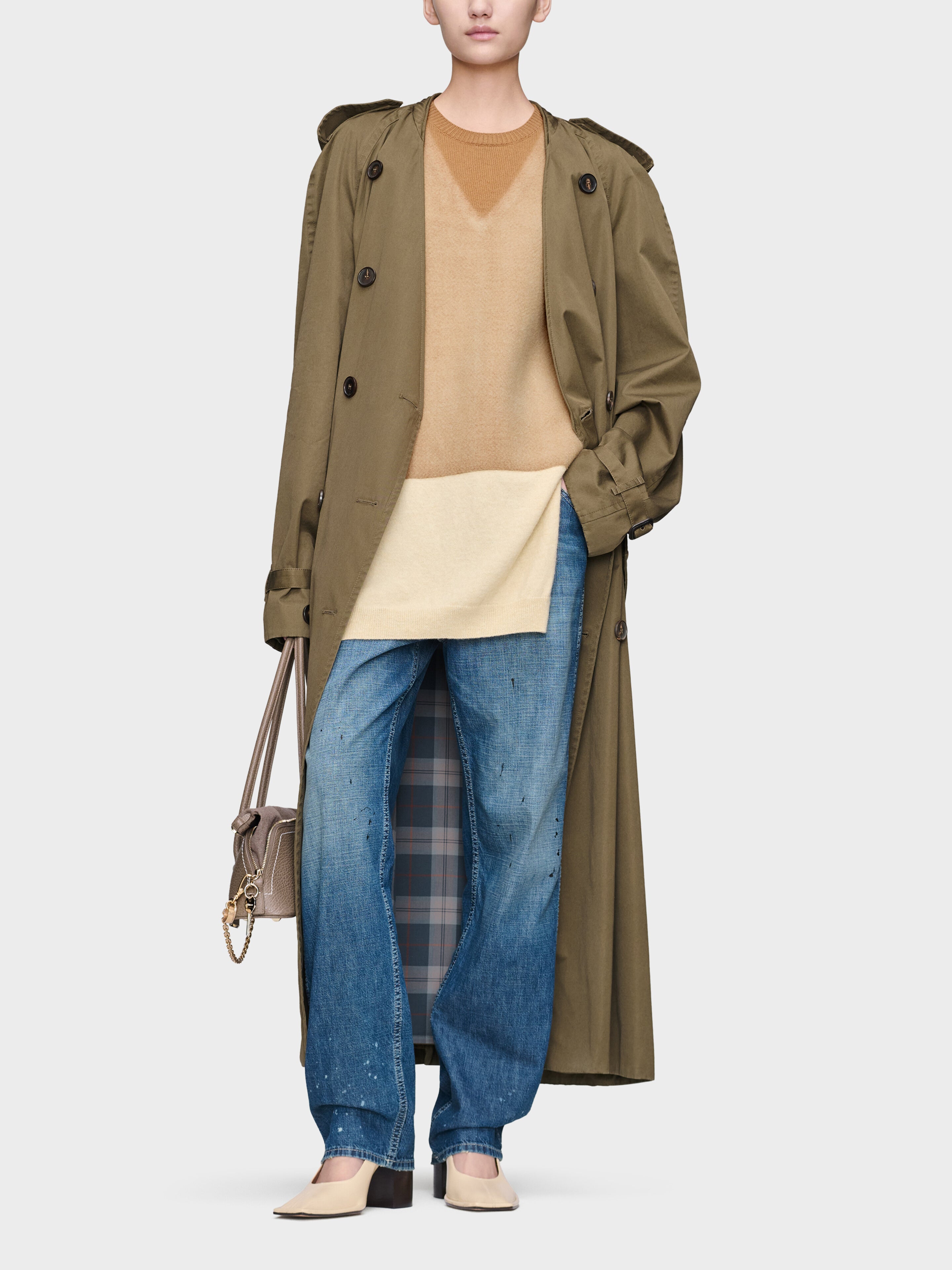 Maison Margiela Fuse Knit Top in camel ecru styled with coat and jeans, featuring elongated wool knit silhouette and layered effect