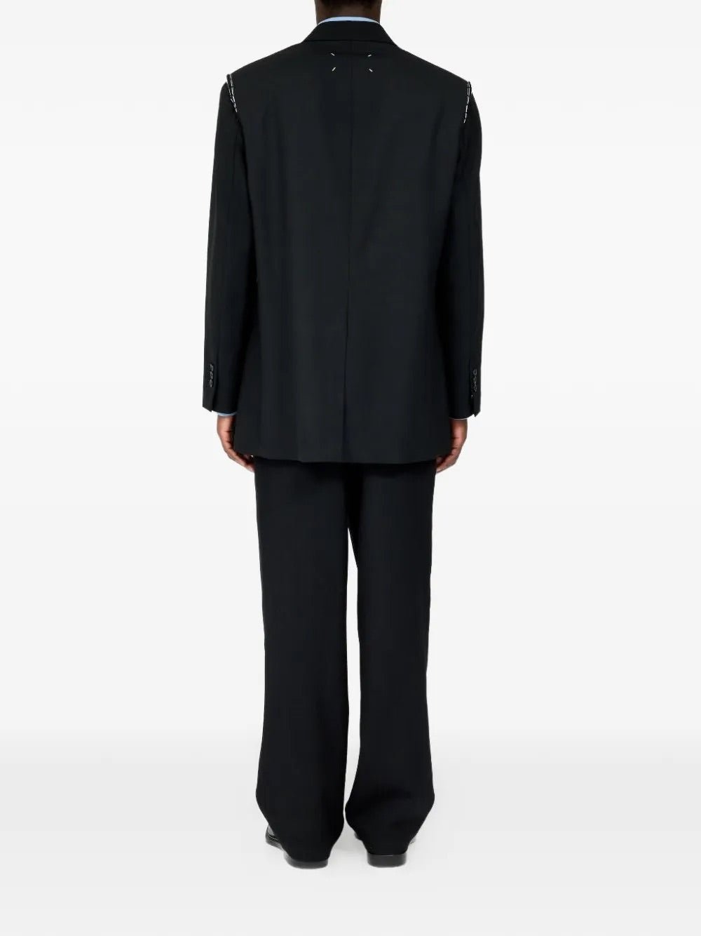 Male model wearing Maison Margiela Black Blazer, back view, highlighting tailored fit and smooth virgin wool fabric.