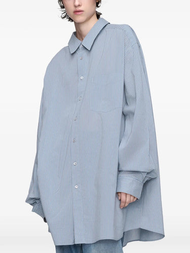 Close-up, front view of model wearing the long-sleeved shirt in light blue and grey from Maison Margiela