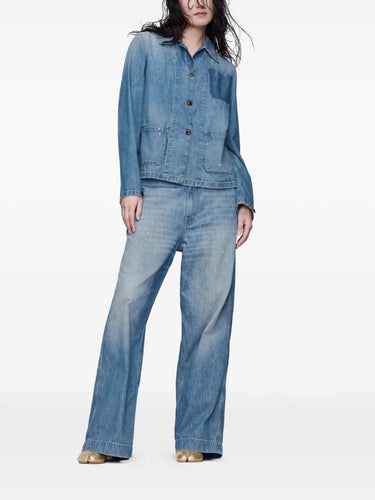 Front view of a model wearing the Long-Sleeved Shirt in Medium Blue Vintage by Maison Margiela, highlighting the blue denim fabric, classic collar, and front button closure.