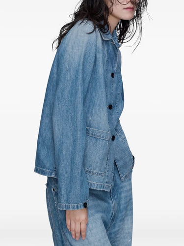Close-up side view of a model wearing the Long-Sleeved Shirt in Medium Blue Vintage by Maison Margiela, showing the structure of the denim fabric and the relaxed silhouette.