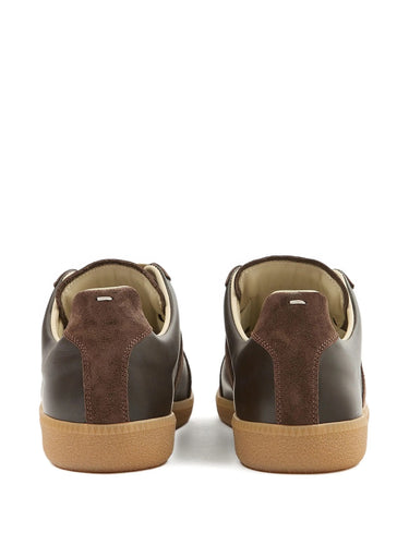 Brown sneakers with tan soles on a white background