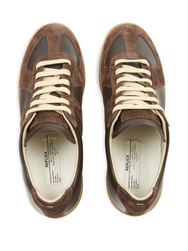 Brown sneakers with white laces on a white background