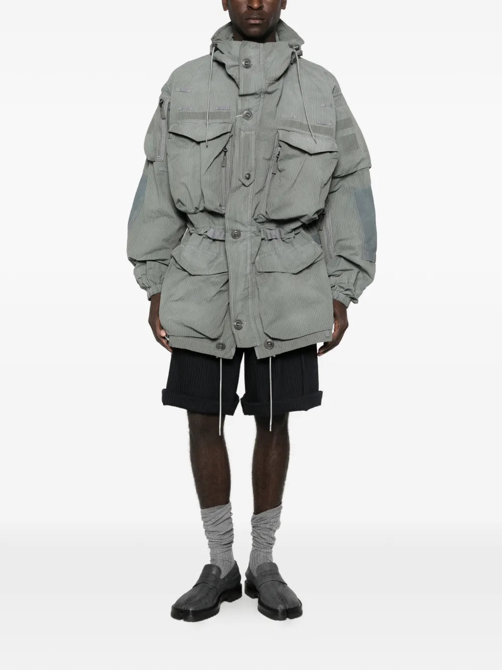 Front view of a model wearing the Men's Sports Jacket in Sage from Maison Margiela